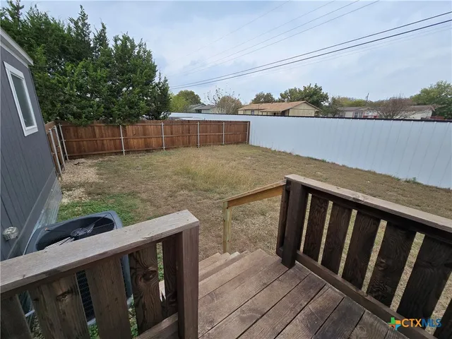 a view of a balcony with wooden floor