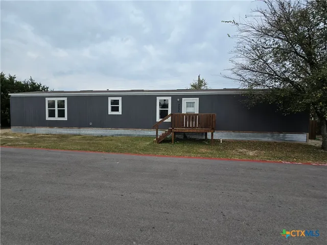 a view of house with outdoor space and bathroom