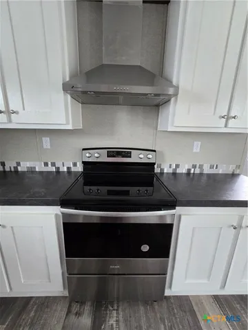 a stove top oven sitting inside of a kitchen