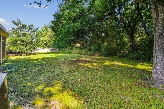 a bathroom with a granite countertop sink a mirror and shower