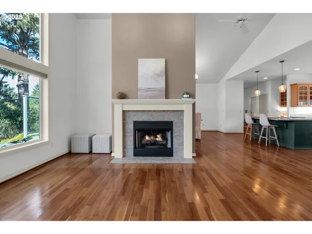 a view of a livingroom with furniture a fireplace and wooden floor
