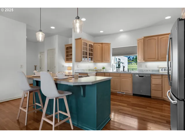a kitchen with a sink cabinets and wooden floor