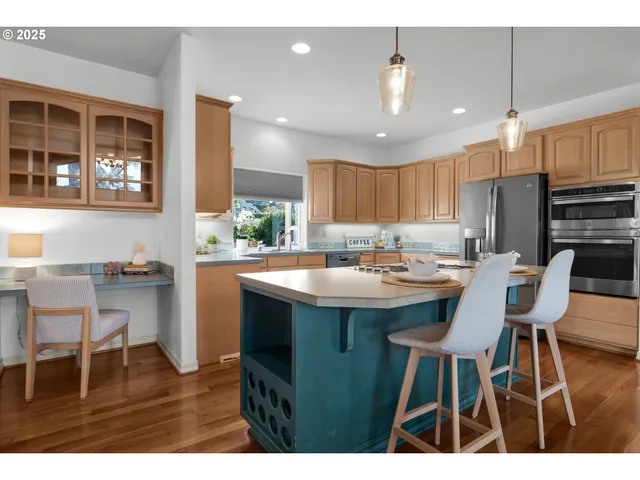 a kitchen with kitchen island a sink table and chairs