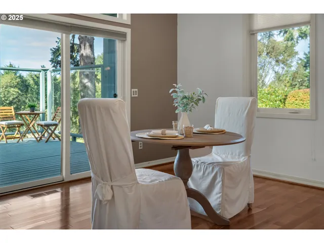a dining room with furniture and wooden floor