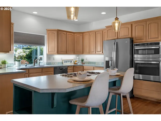 a kitchen with refrigerator and chairs