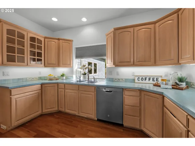 a kitchen with granite countertop cabinets sink and window