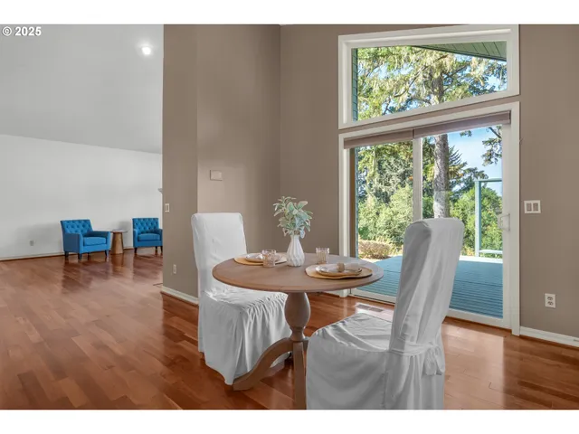 a dining room with furniture and wooden floor