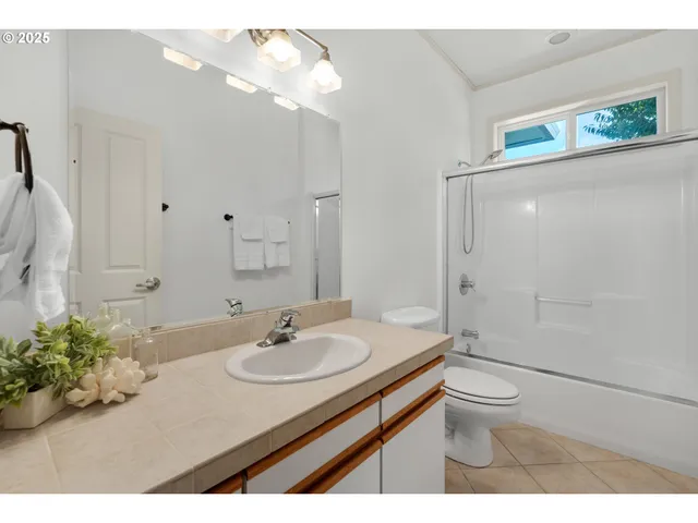 a bathroom with a sink toilet a mirror and shower