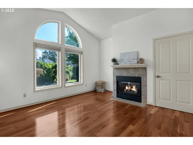 a view of an empty room with a fireplace and a window
