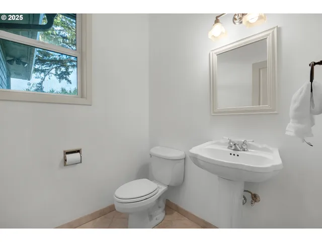 a bathroom with a sink mirror and toilet