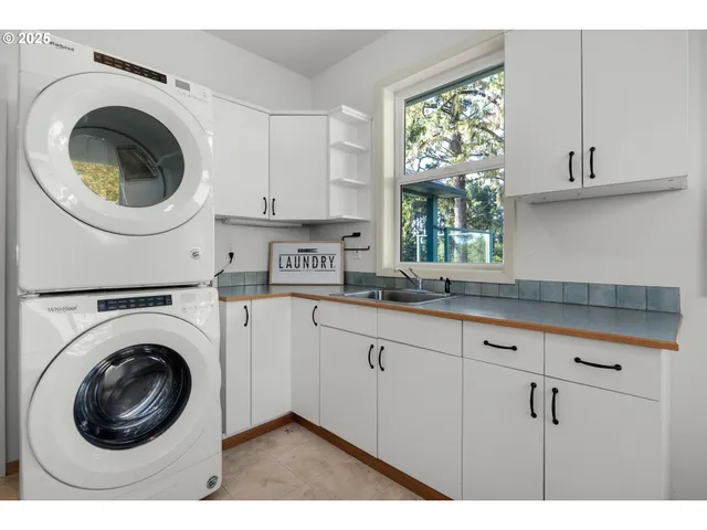 a kitchen that has a lot of cabinets and a sink
