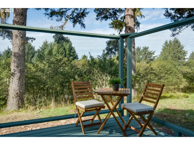 a view of a chair and table on the balcony