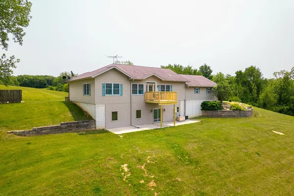 a front view of a house with yard and green space