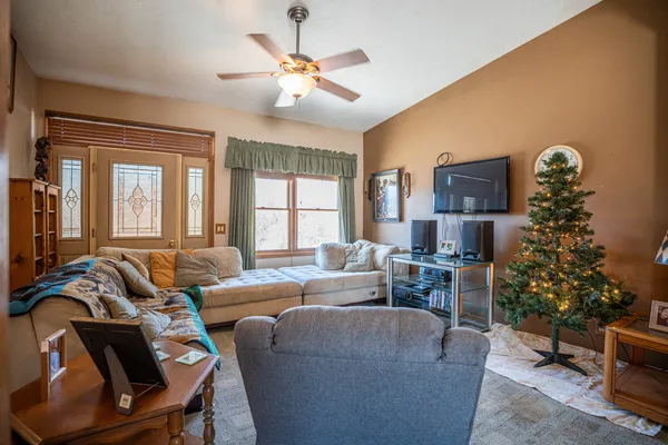 a kitchen with stainless steel appliances granite countertop a sink dishwasher stove top oven a dining table and chairs with wooden floor