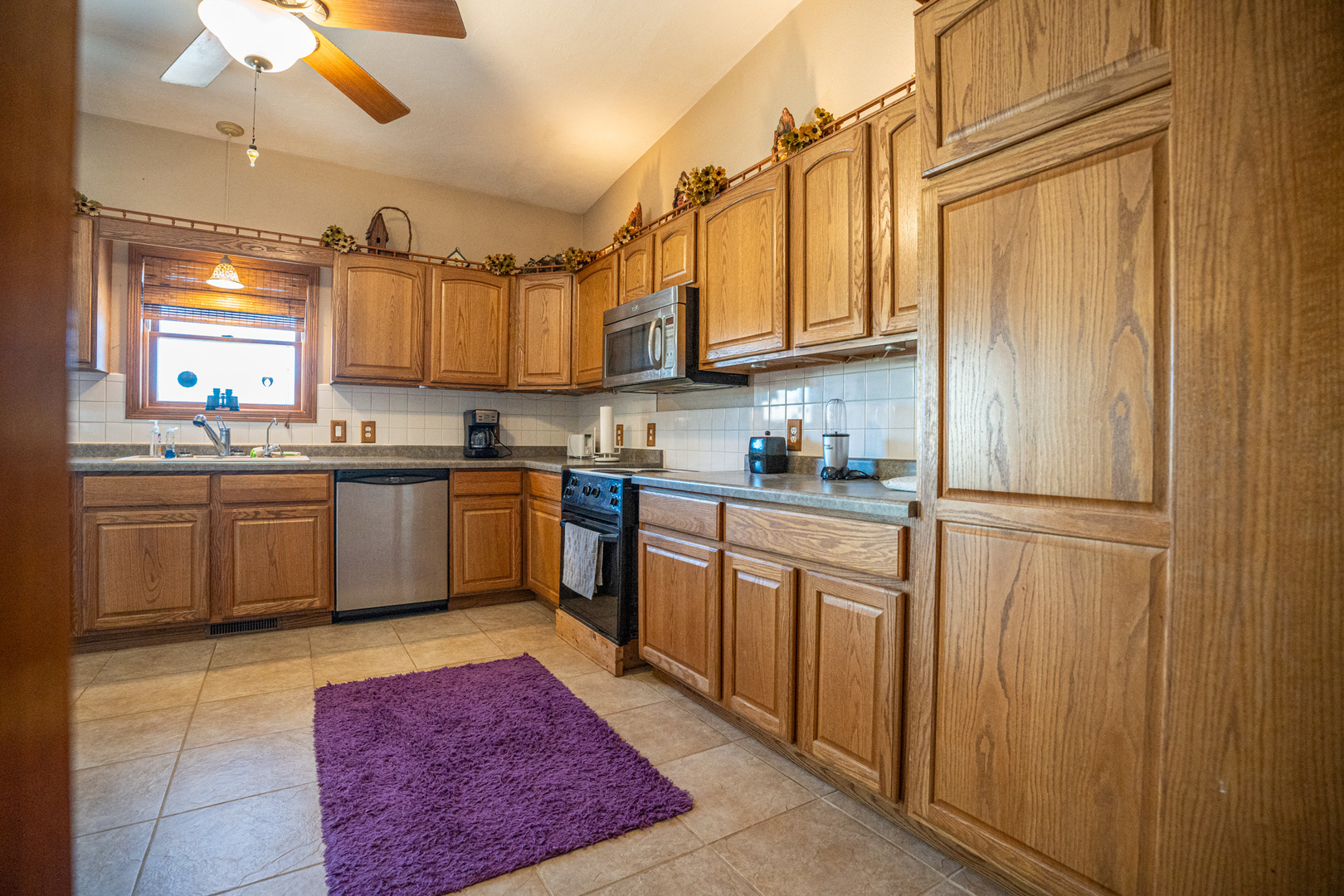 9304 Ellis Road Fenton, IL 61251 - Photo 22 of 81 a kitchen with stainless steel appliances granite countertop a sink a stove cabinets and a refrigerator
