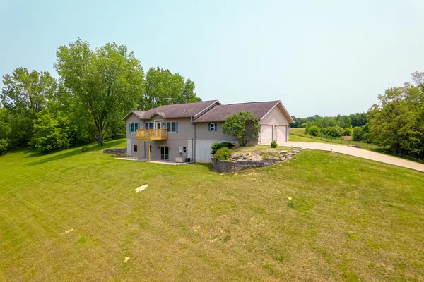a front view of house with yard and lake view