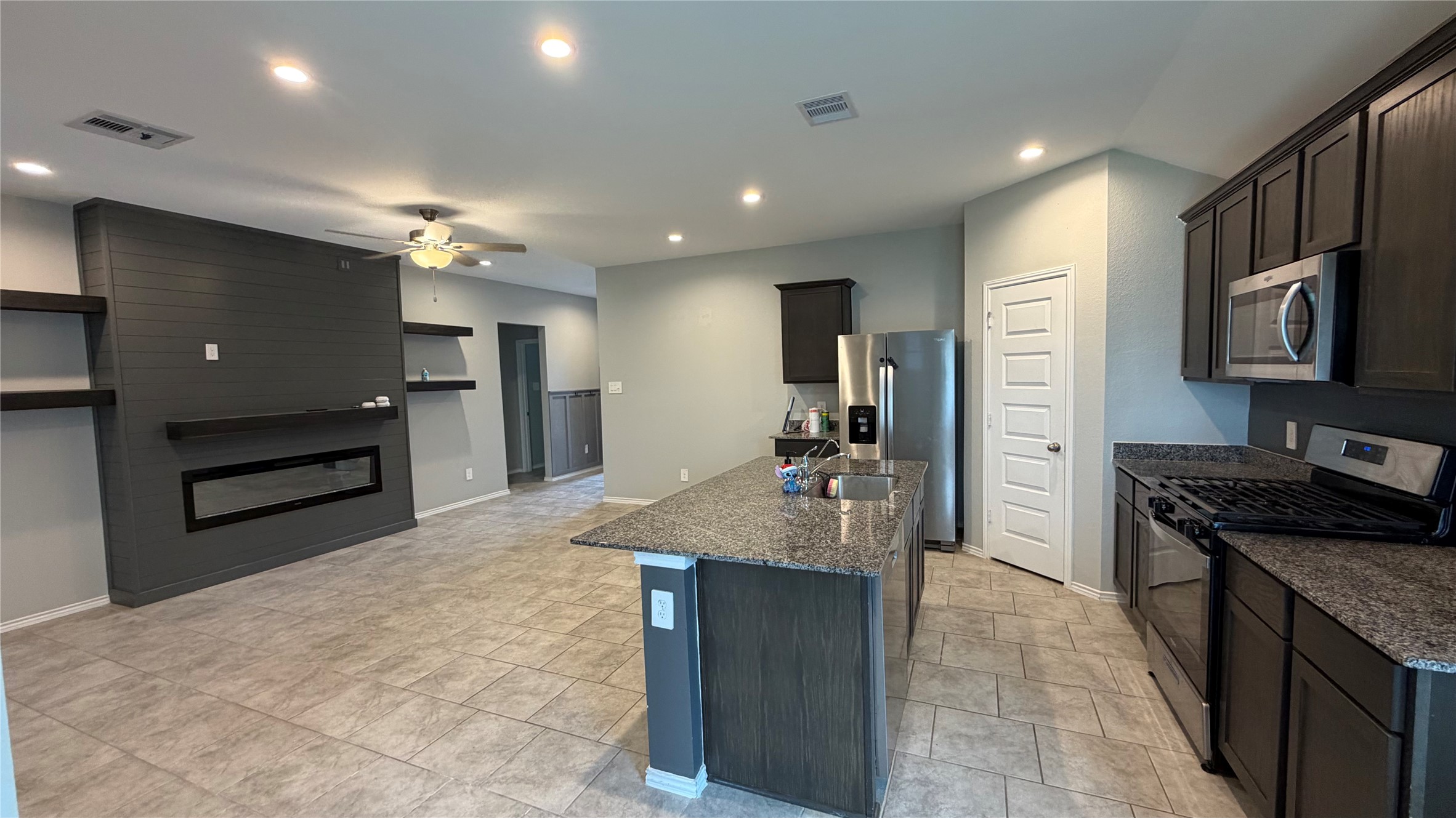 7518 Cynomys Court Rosharon, TX 77583 - Photo 6 of 21 a kitchen with kitchen island sink and refrigerator