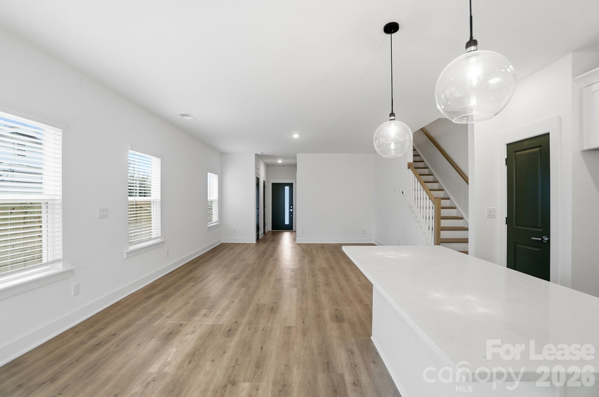 3945 Tillman Road Charlotte, NC 28208 - Photo 14 of 47 a view of an empty room with wooden floor and a window
