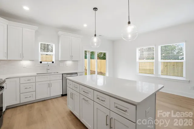 a kitchen with sink stove and cabinets