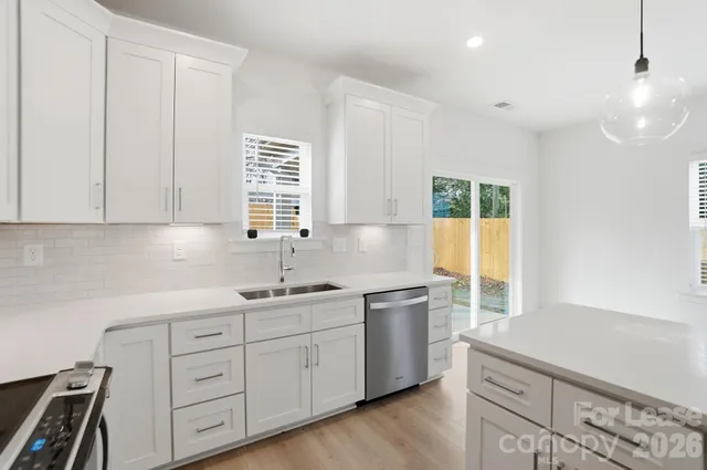 a kitchen with sink cabinets and window