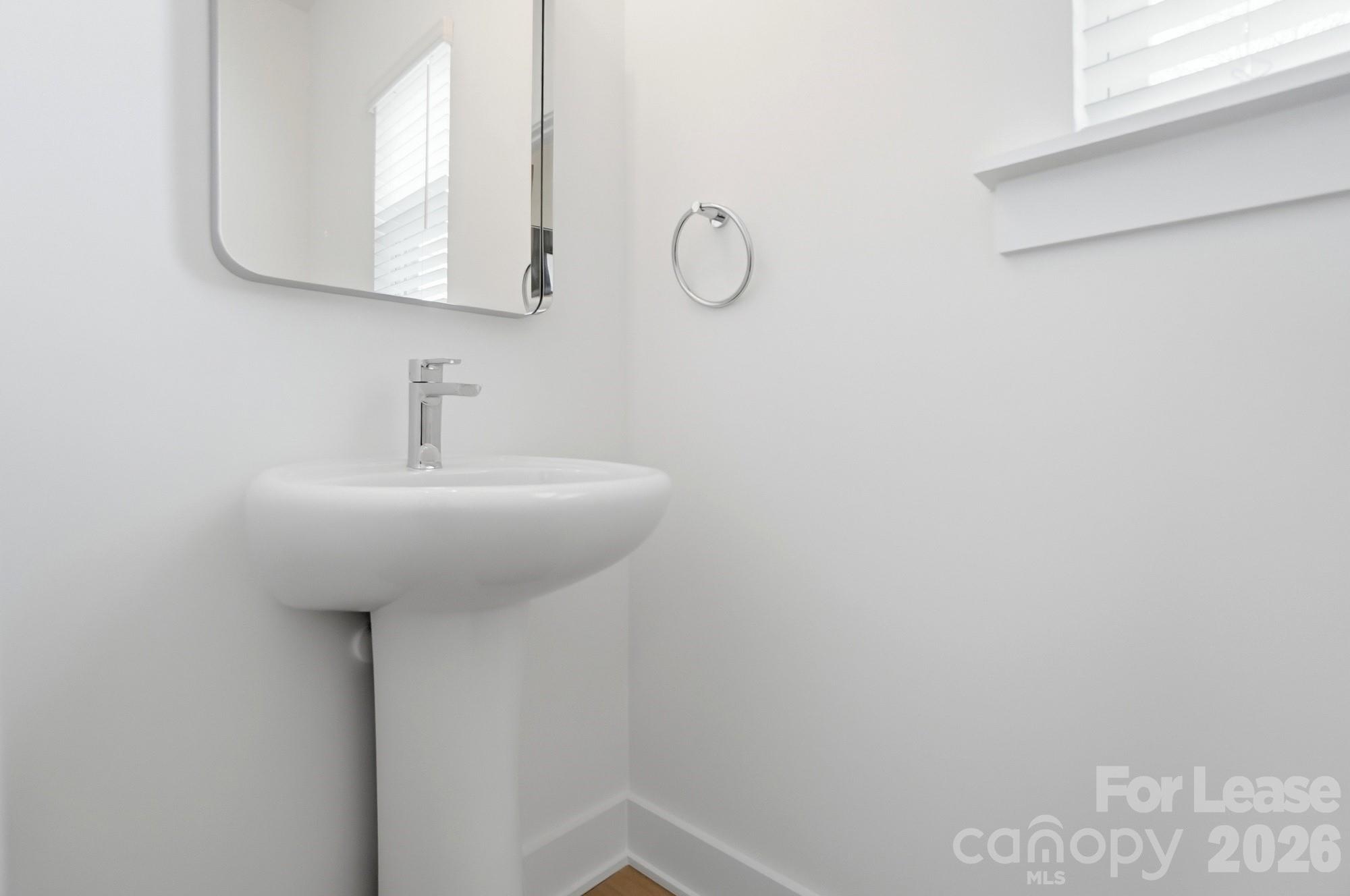 3945 Tillman Road Charlotte, NC 28208 - Photo 20 of 47 a bathroom with a sink and mirror
