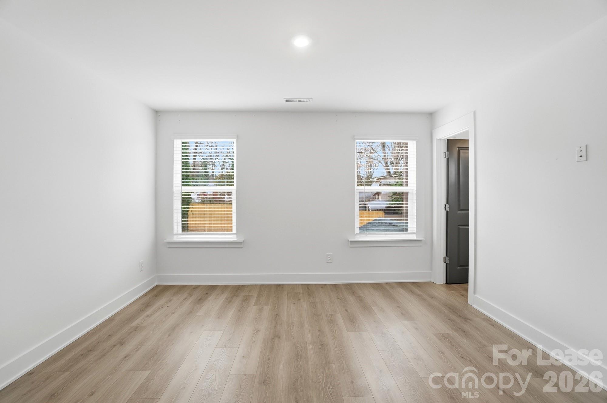 3945 Tillman Road Charlotte, NC 28208 - Photo 23 of 47 an empty room with wooden floor and windows
