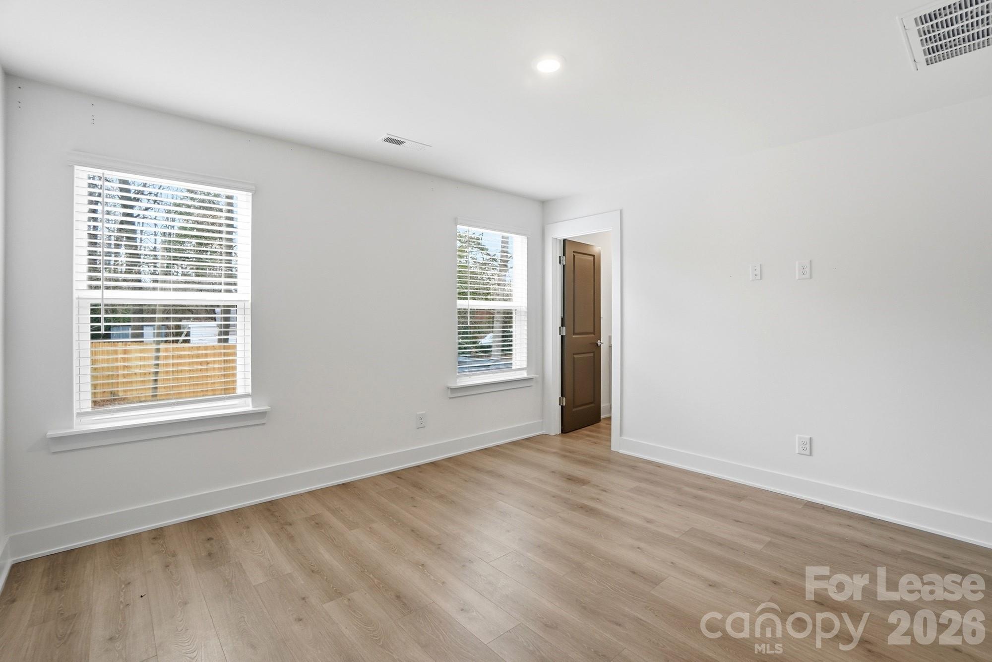3945 Tillman Road Charlotte, NC 28208 - Photo 24 of 47 an empty room with wooden floor and windows