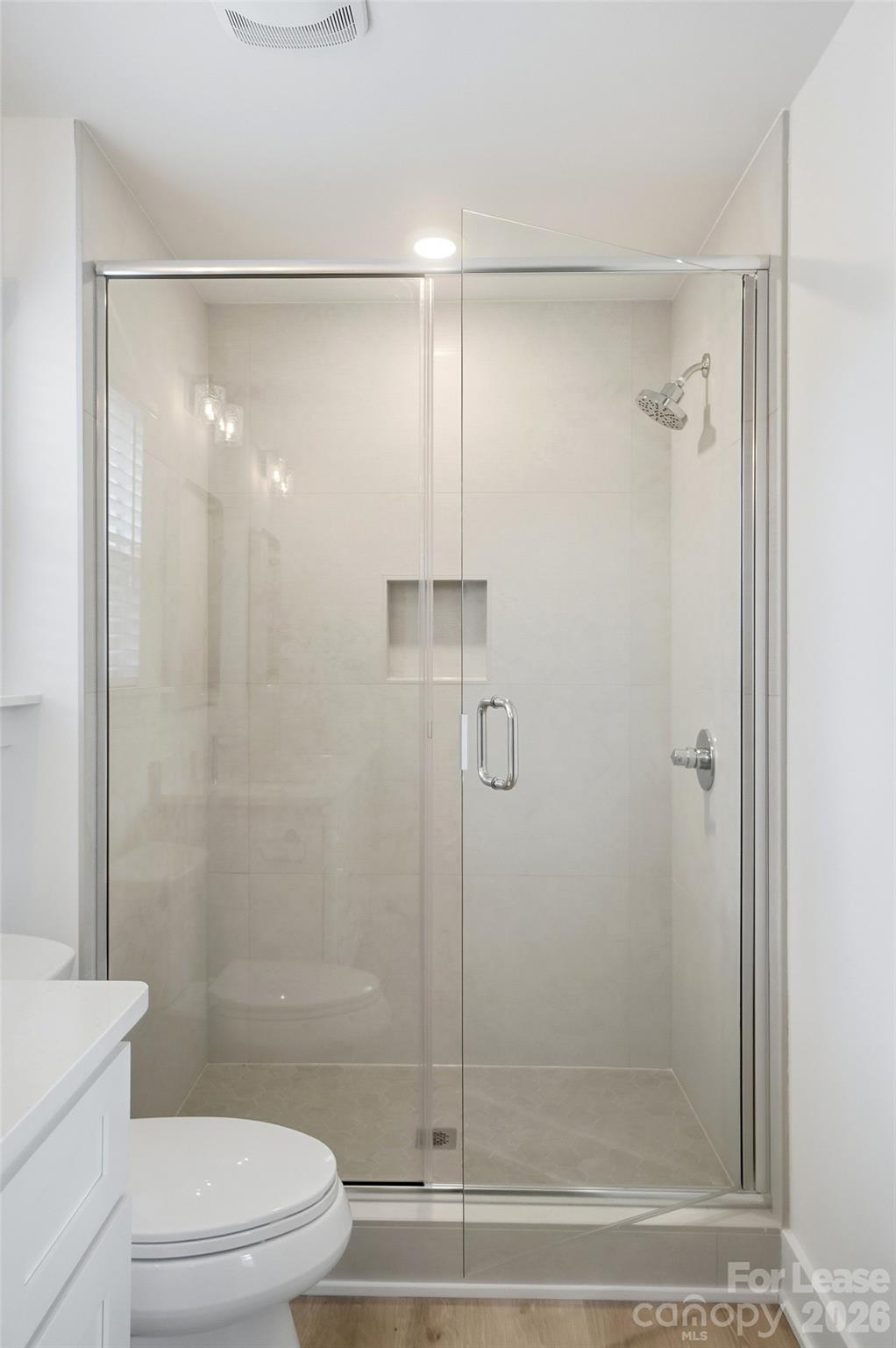 3945 Tillman Road Charlotte, NC 28208 - Photo 31 of 47 a bathroom with a shower a toilet and a glass door shower