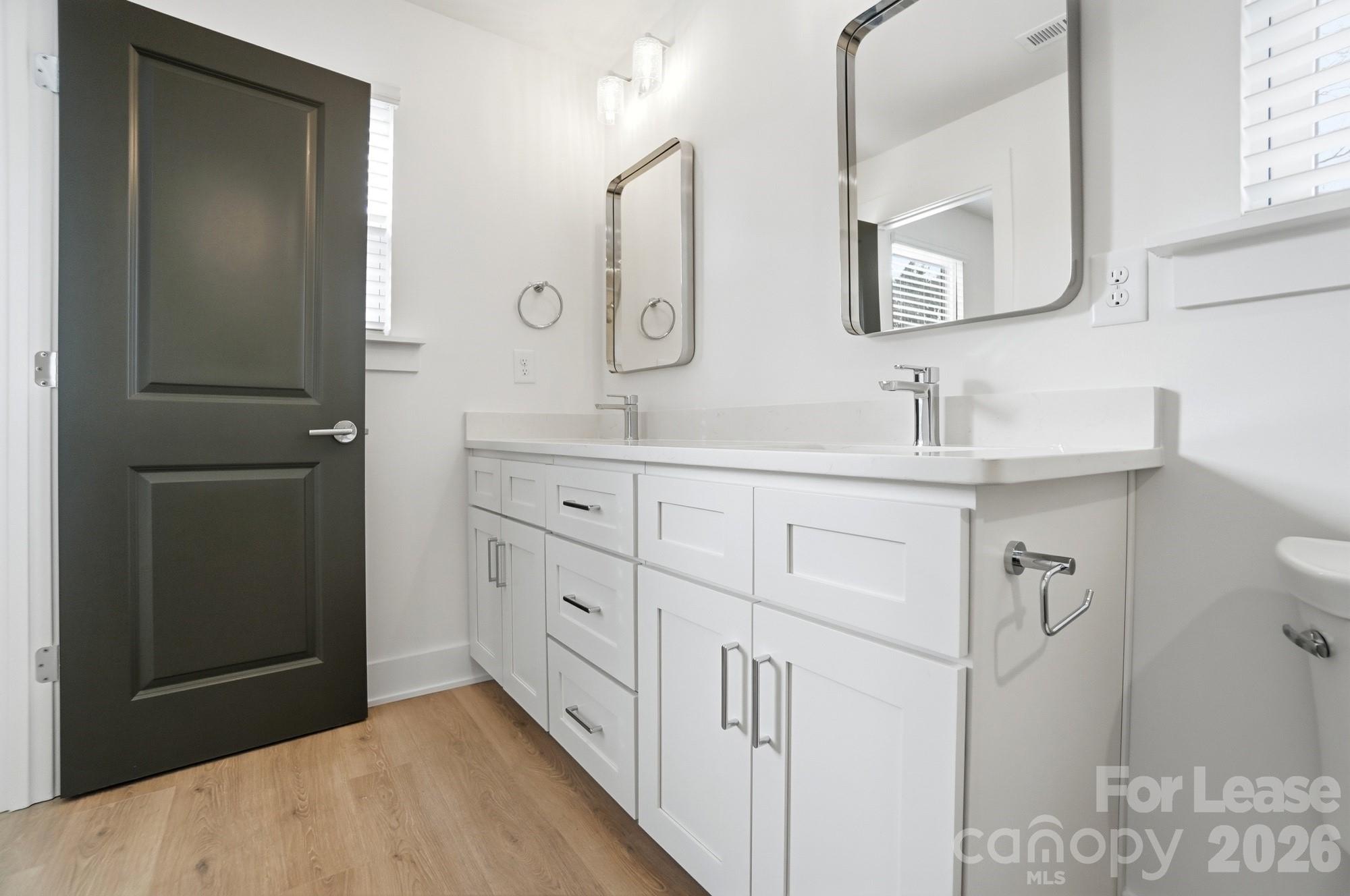 3945 Tillman Road Charlotte, NC 28208 - Photo 32 of 47 a bathroom with a double vanity sink mirror and