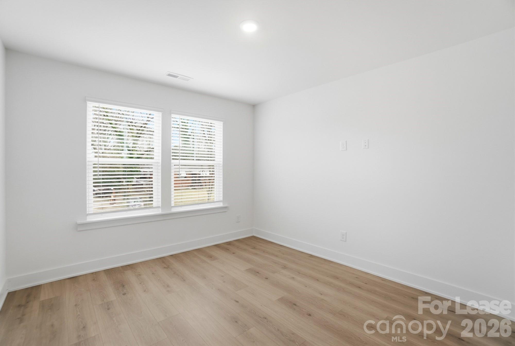 3945 Tillman Road Charlotte, NC 28208 - Photo 34 of 47 a view of an empty room with wooden floor and a window