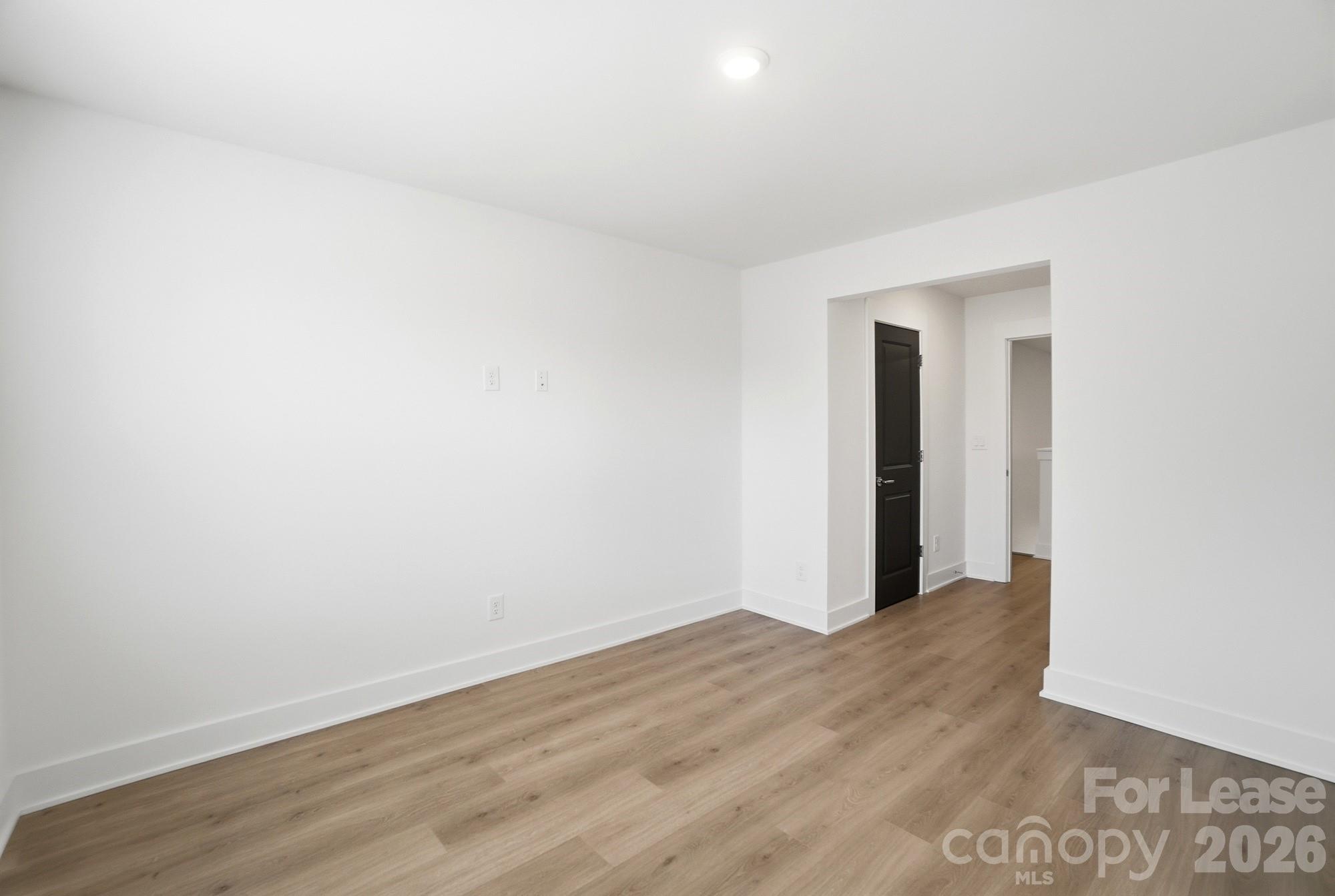3945 Tillman Road Charlotte, NC 28208 - Photo 35 of 47 a view of an empty room with wooden floor and closet
