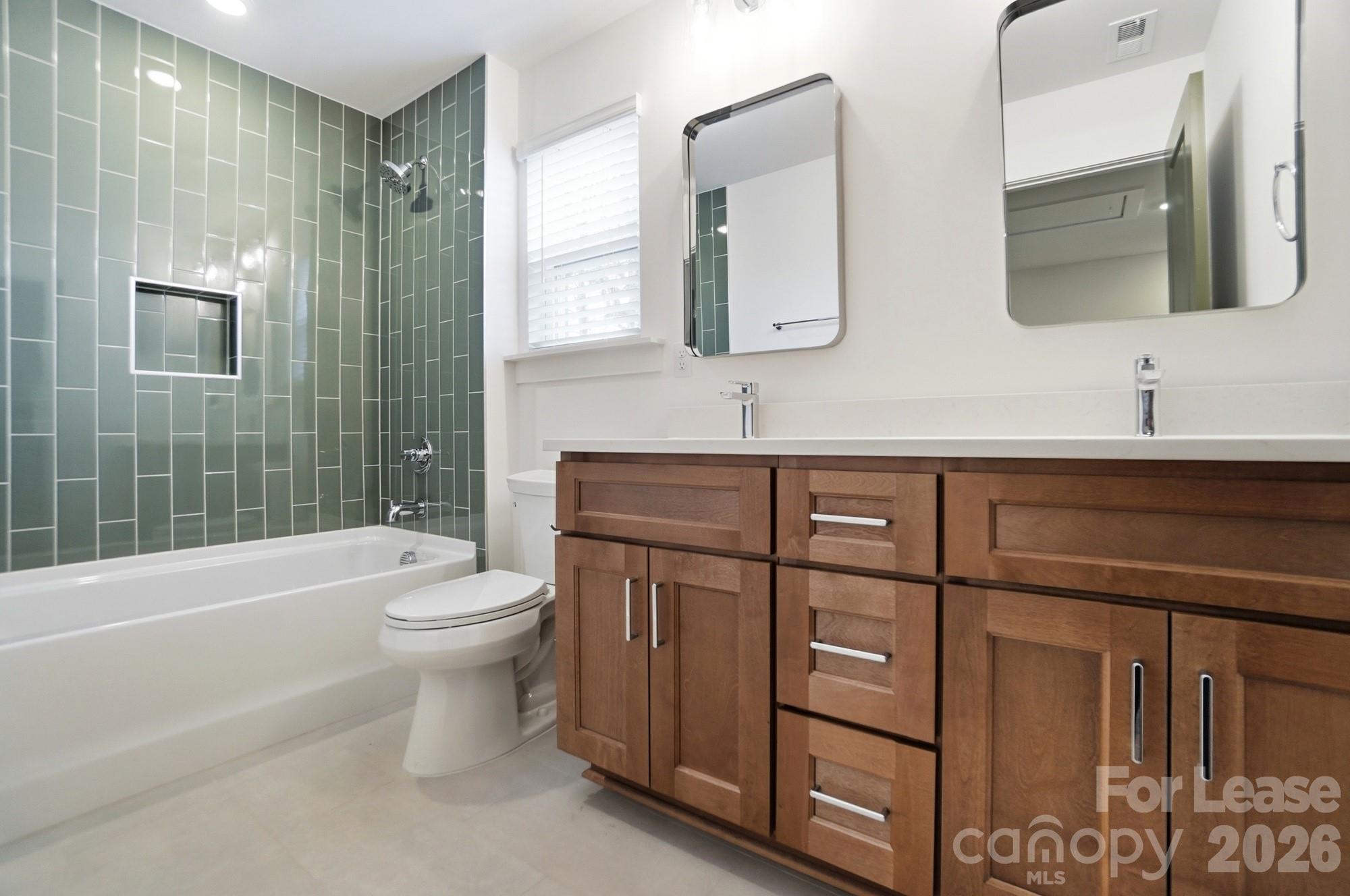 3945 Tillman Road Charlotte, NC 28208 - Photo 36 of 47 a bathroom with a toilet a sink a tub and mirror