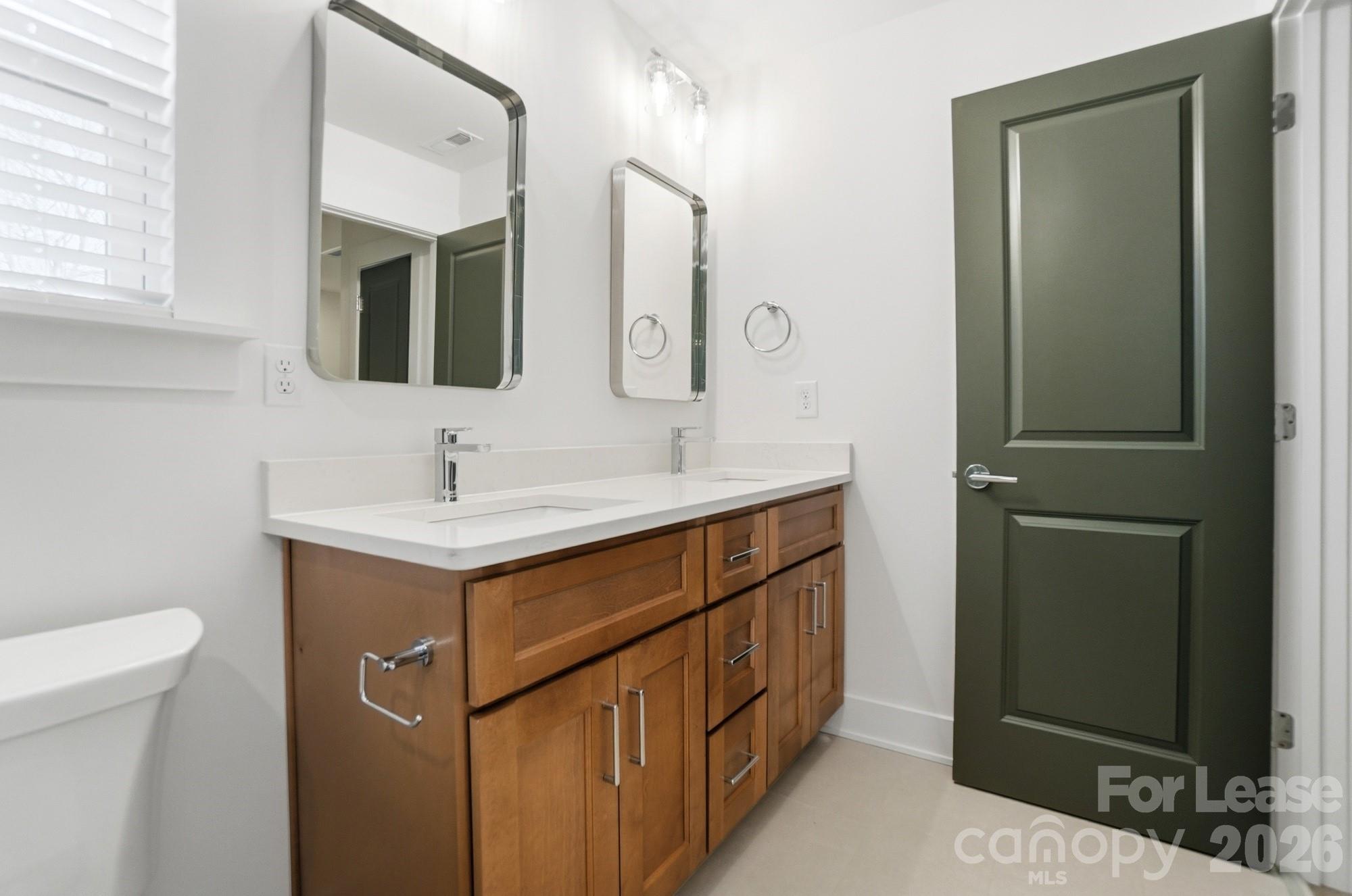 3945 Tillman Road Charlotte, NC 28208 - Photo 37 of 47 a bathroom with a sink double vanity and a mirror