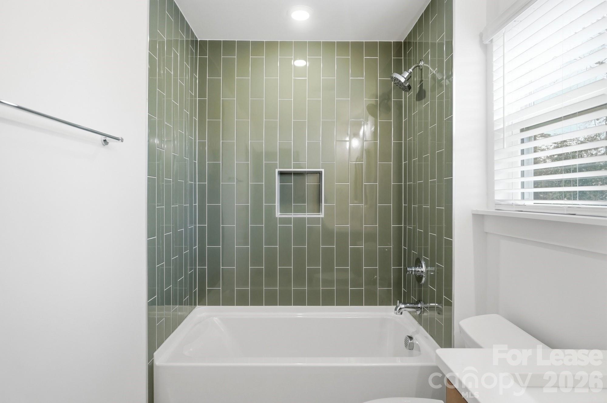 3945 Tillman Road Charlotte, NC 28208 - Photo 38 of 47 a bathroom with a bathtub and shower