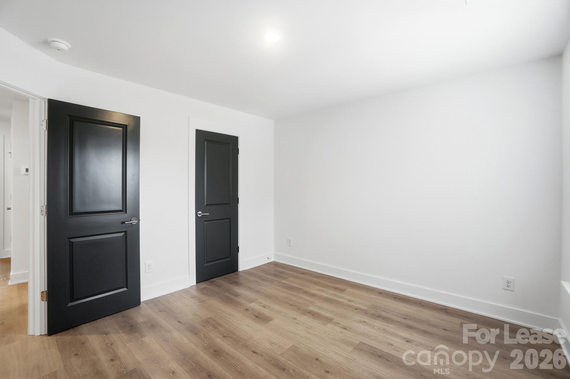 3945 Tillman Road Charlotte, NC 28208 - Photo 40 of 47 a view of empty room with wooden floor