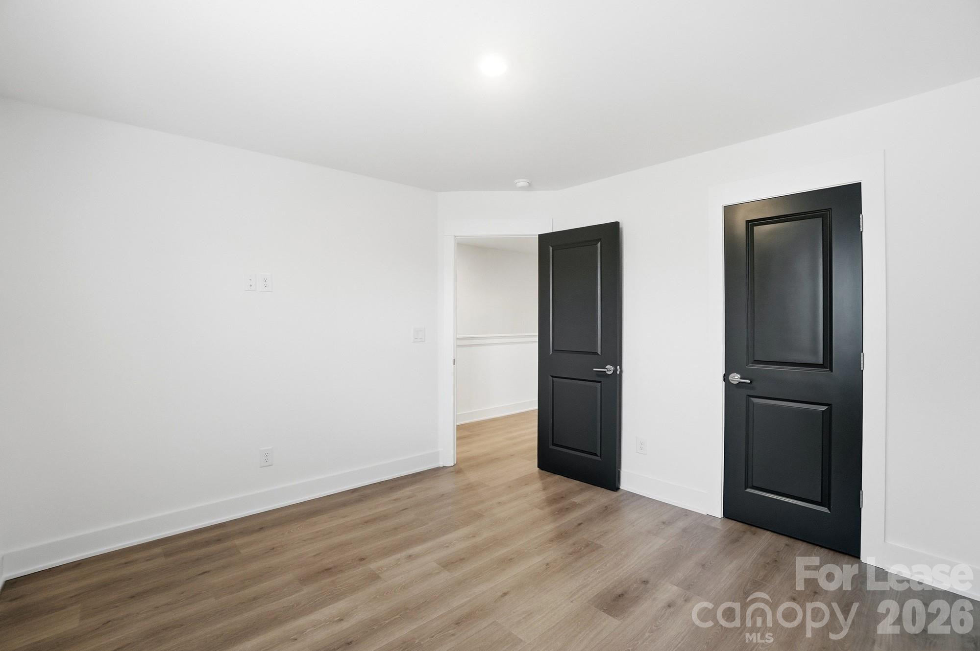 3945 Tillman Road Charlotte, NC 28208 - Photo 41 of 47 an empty room with wooden floor and closet