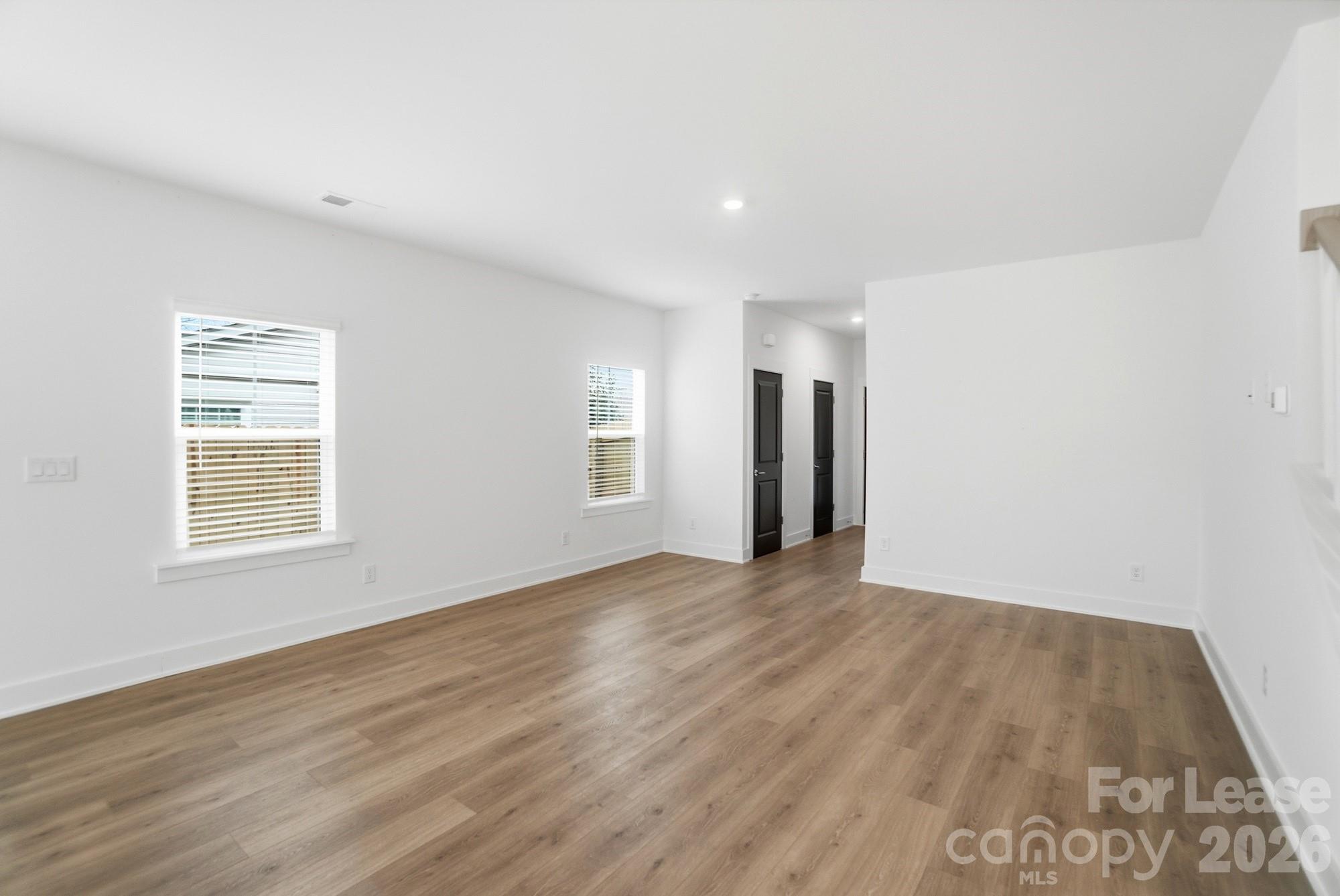 3945 Tillman Road Charlotte, NC 28208 - Photo 9 of 47 a view of an empty room with wooden floor and a window