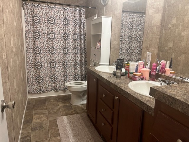 168 Liberty Road Winchester, TN 37398 - Photo 9 of 13 a bathroom with a double vanity sink toilet and shower