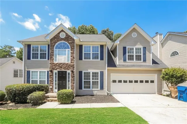 a front view of a house with a yard