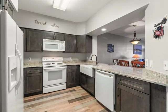 a kitchen with stainless steel appliances granite countertop a sink and a stove top oven