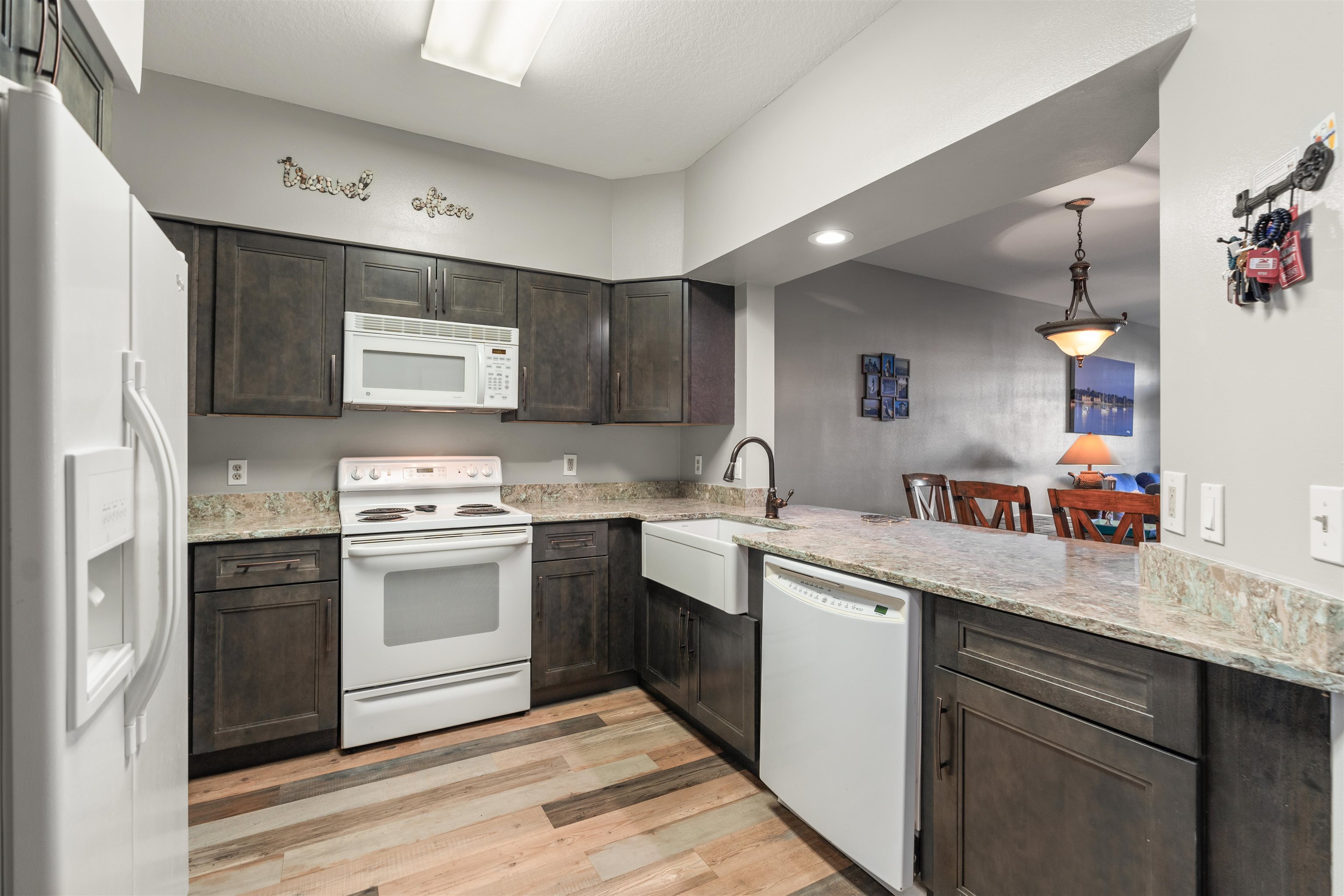 a kitchen with stainless steel appliances granite countertop a sink and a stove top oven