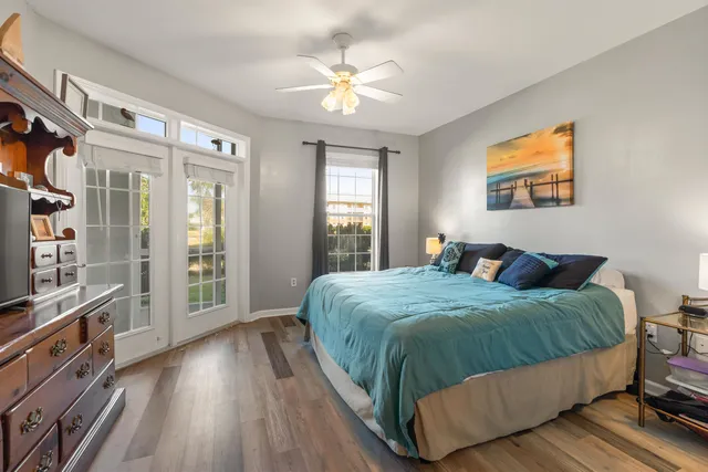 a bedroom with a large bed and a flat tv screen on dresser