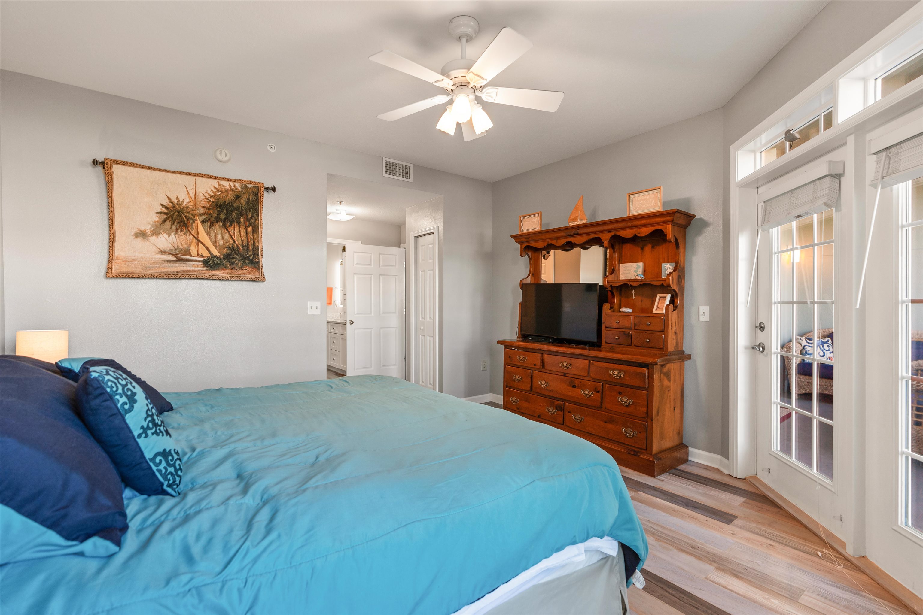 265 Atlantis Circle, Unit 102 St. Augustine Beach, FL 32080 - Photo 13 of 38 a bedroom with a bed and a chandelier