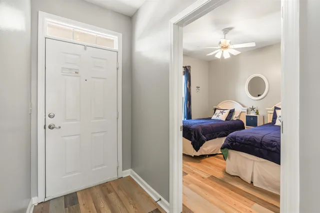 a bedroom with bed and wooden floor