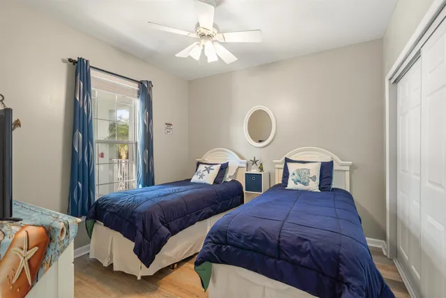 a spacious bedroom with two beds and a chandelier