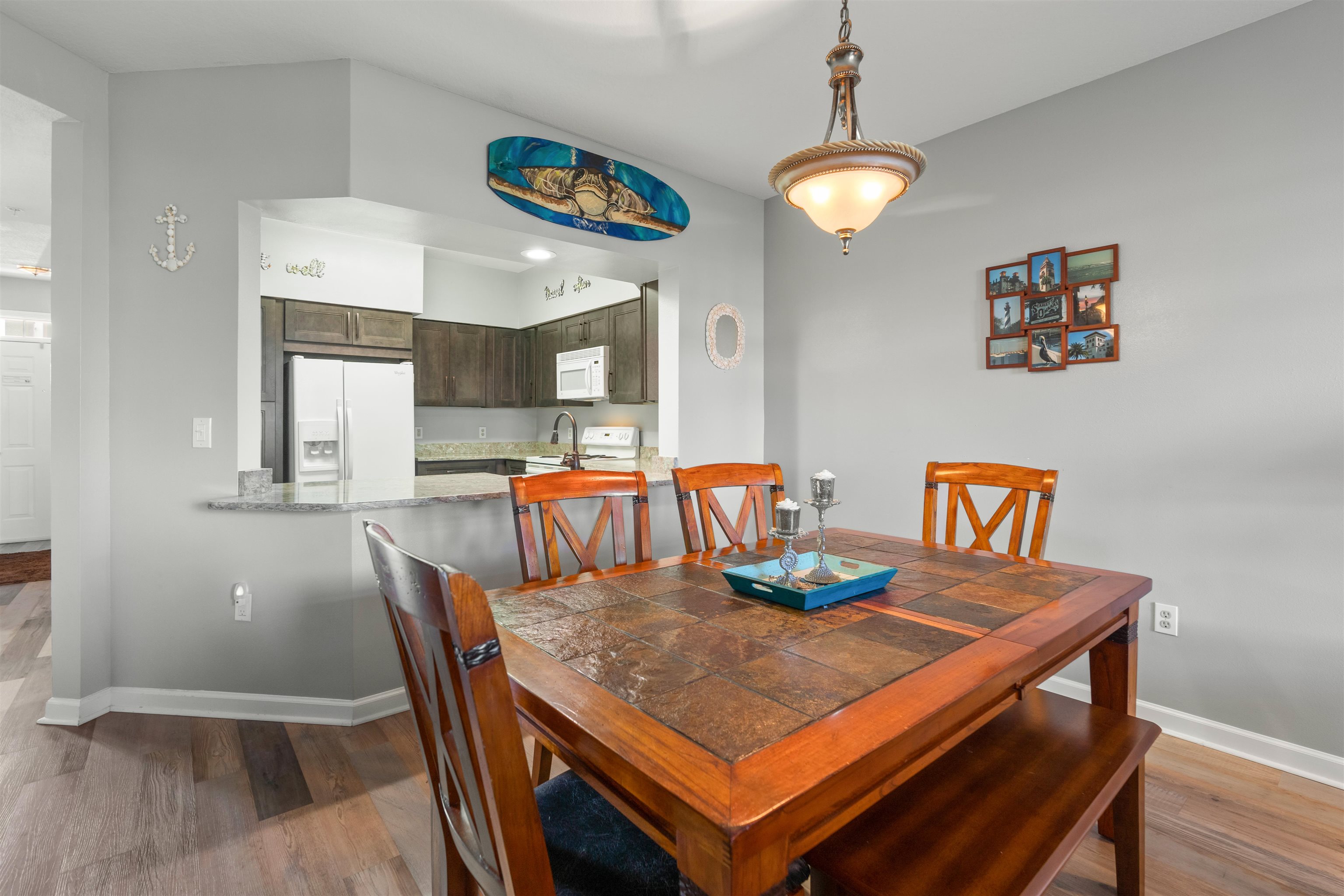 265 Atlantis Circle, Unit 102 St. Augustine Beach, FL 32080 - Photo 24 of 38 a view of a dining room with furniture and wooden floor