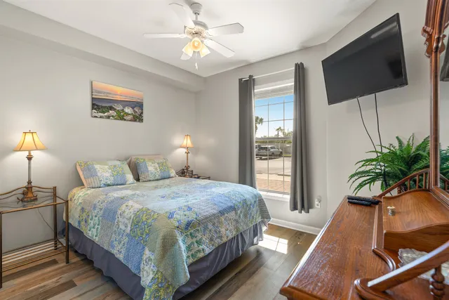 a bedroom with a bed and a flat screen tv