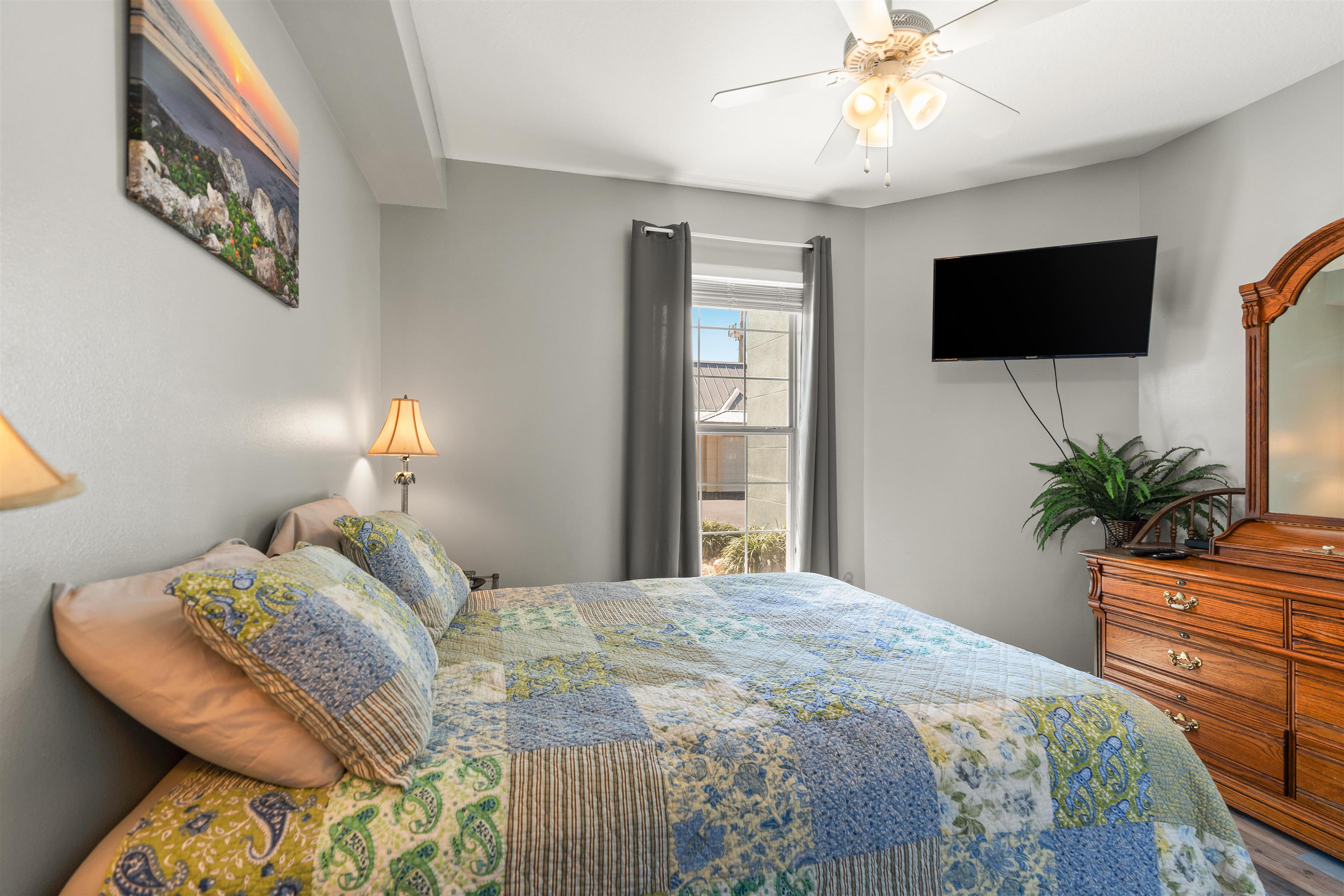 265 Atlantis Circle, Unit 102 St. Augustine Beach, FL 32080 - Photo 27 of 38 a bedroom with a bed and a flat screen tv