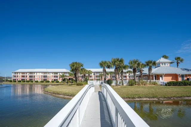 a view of residential houses with outdoor space and lake view