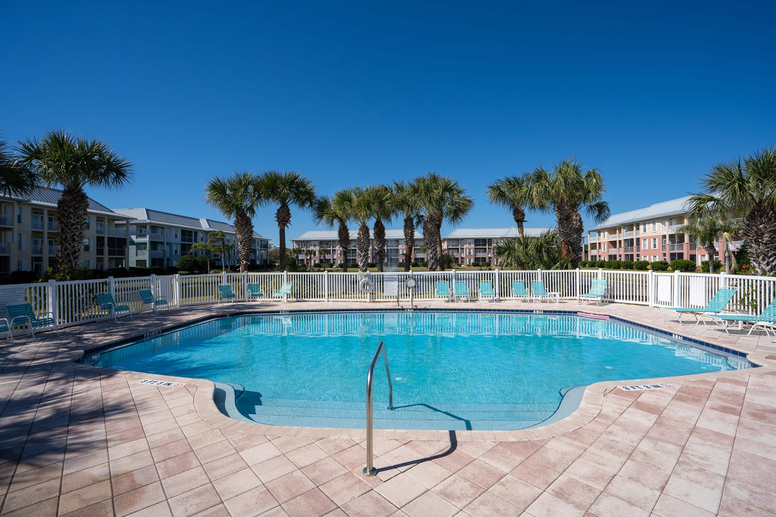 265 Atlantis Circle, Unit 102 St. Augustine Beach, FL 32080 - Photo 35 of 38 a view of a swimming pool and lounge chairs